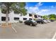 Exterior view of condos showing parking spaces and black awnings over windows at 120 S Church Ave # 202, Tampa, FL 33609