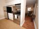 An eat-in kitchen with stainless steel appliances and tile floors abuts a cozy living room at 120 S Church Ave # 202, Tampa, FL 33609