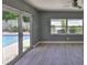 Bedroom overlooking the pool area with tiled floors and large windows for natural light at 12372 113Th St, Largo, FL 33778