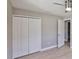 Bedroom featuring light wood floors, paneled closet doors and a doorway to another room at 12372 113Th St, Largo, FL 33778