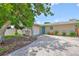 Charming single Gathering home featuring a blue front door and well-maintained landscaping at 12372 113Th St, Largo, FL 33778