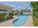 A backyard swimming pool has lush plant life surrounding for privacy at 12372 113Th St, Largo, FL 33778