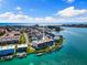 Panoramic aerial shot showcasing waterfront condo complex with docks, water access, and tropical landscaping at 12525 3Rd E St # 303, Treasure Island, FL 33706