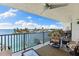 Cozy balcony features comfortable seating with beautiful waterfront view at 12525 3Rd E St # 303, Treasure Island, FL 33706