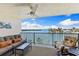 Outdoor balcony features ceiling fan and comfortable seating overlooking beautiful views of the water at 12525 3Rd E St # 303, Treasure Island, FL 33706