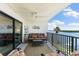 Relaxing outdoor balcony featuring ceiling fan and comfortable seating overlooking water views at 12525 3Rd E St # 303, Treasure Island, FL 33706