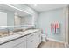 Spacious bathroom with double vanity, granite countertop, decorative mirrors and a glass enclosed shower at 12525 3Rd E St # 303, Treasure Island, FL 33706