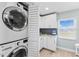Laundry room with stackable washer/dryer and adjacent cabinets at 12525 3Rd E St # 303, Treasure Island, FL 33706