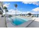 Relaxing waterfront community pool featuring lounge chairs, boat dock views, and a refreshing escape at 12525 3Rd E St # 303, Treasure Island, FL 33706