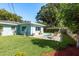 A backyard with a plunge pool, lawn, and patio is a welcome addition to this home at 1281 Robin Hood Ln, Dunedin, FL 34698