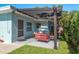 Charming backyard patio with comfortable seating and a lush green lawn at 1281 Robin Hood Ln, Dunedin, FL 34698