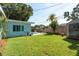 Beautiful backyard featuring a fenced yard, plunge pool, and lawn with landscaping at 1281 Robin Hood Ln, Dunedin, FL 34698