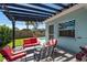 Inviting patio with outdoor seating overlooking the pool and lush backyard at 1281 Robin Hood Ln, Dunedin, FL 34698