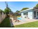 Inviting backyard with a pool, lounge chairs, and a charming storage shed at 1281 Robin Hood Ln, Dunedin, FL 34698