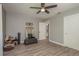 Cozy bedroom with wood-look flooring, ceiling fan, and doorway leading to another room at 1281 Robin Hood Ln, Dunedin, FL 34698