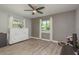 Light-filled bedroom with wood-look flooring, ceiling fan, and abundant natural light from two windows at 1281 Robin Hood Ln, Dunedin, FL 34698