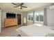 Bright main bedroom features hardwood floors, large windows, and a ceiling fan at 1281 Robin Hood Ln, Dunedin, FL 34698