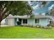 Charming one-story home with a well-maintained lawn and blue exterior at 1281 Robin Hood Ln, Dunedin, FL 34698