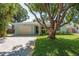 Charming one-story home with a well-maintained lawn and brick driveway at 1281 Robin Hood Ln, Dunedin, FL 34698