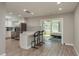 Open kitchen with stainless steel appliances and view into bright bedroom at 1281 Robin Hood Ln, Dunedin, FL 34698