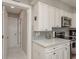 Kitchen featuring white cabinets, quartz countertops, subway tile backsplash, and stainless appliances at 1281 Robin Hood Ln, Dunedin, FL 34698