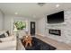 Cozy living room with modern flooring, fireplace, and a dark front door at 1281 Robin Hood Ln, Dunedin, FL 34698