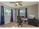 Bright office with wood-look flooring, large windows, and black office furniture at 1281 Robin Hood Ln, Dunedin, FL 34698