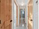Hallway view with wooden doors leading to rooms, highlighting natural light and modern design at 13323 Susan Dr, Hudson, FL 34667