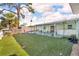 The backyard has an artificial lawn and a covered patio at 13929 Muriel Ave, Hudson, FL 34667