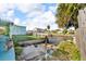 Home backyard featuring a canal view, a storage shed, and grassy area at 13929 Muriel Ave, Hudson, FL 34667