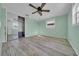 Light and bright bedroom features blue walls, a ceiling fan and closet with mirrored doors at 13929 Muriel Ave, Hudson, FL 34667
