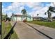 A street-side view of the home with a spacious driveway and colorful exterior at 13929 Muriel Ave, Hudson, FL 34667