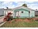 Charming front exterior featuring a quaint painted facade with red bougainvillea at 13929 Muriel Ave, Hudson, FL 34667