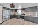 Modern kitchen featuring stainless steel appliances, stone countertops, and stylish cabinetry at 13929 Muriel Ave, Hudson, FL 34667