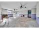 Unfinished living room featuring dual ceiling fans and a set of patio doors at 13929 Muriel Ave, Hudson, FL 34667