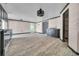 Open-concept living and kitchen area with modern lighting and ceramic flooring at 13929 Muriel Ave, Hudson, FL 34667