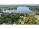 A high-angle shot of a house on a tree-covered lot along a scenic lake at 14449 Wadsworth Dr, Odessa, FL 33556