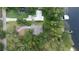 Aerial view of a property on the water, featuring a private dock and verdant surroundings at 14449 Wadsworth Dr, Odessa, FL 33556