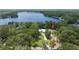 Beautiful lakeside property, featuring a long driveway and lovely landscaping, nestled near a scenic lake at 14449 Wadsworth Dr, Odessa, FL 33556
