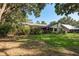 Lush backyard featuring mature trees, shrubs, and well-maintained lawn, showcasing the home's outdoor space at 14449 Wadsworth Dr, Odessa, FL 33556