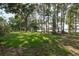Expansive backyard featuring mature trees, a fire pit, and waterfront access, perfect for outdoor enjoyment at 14449 Wadsworth Dr, Odessa, FL 33556