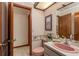 Compact bathroom featuring a pink toilet and sink, and striped wallpaper at 14449 Wadsworth Dr, Odessa, FL 33556