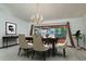 Elegant dining room with a chandelier, table setting and backyard views at 14449 Wadsworth Dr, Odessa, FL 33556