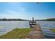 A weathered dock on a calm lake with a bench, offering a peaceful retreat at 14449 Wadsworth Dr, Odessa, FL 33556