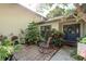 Welcoming front patio with lush landscaping, an elegant rocking chair, and an inviting double-door entrance at 14449 Wadsworth Dr, Odessa, FL 33556