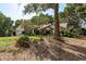 Charming single-Gathering home with well-maintained lawn and landscaping, complemented by mature trees at 14449 Wadsworth Dr, Odessa, FL 33556