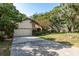 Charming single-Gathering home featuring an attached garage and lush landscaping in a tranquil, residential neighborhood at 14449 Wadsworth Dr, Odessa, FL 33556
