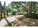 Lovely single-Gathering home with a long driveway and a well-manicured lawn, surrounded by beautiful trees at 14449 Wadsworth Dr, Odessa, FL 33556