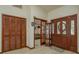Inviting foyer features wood floors, a glass-paneled door, and a view into the cozy living area at 14449 Wadsworth Dr, Odessa, FL 33556