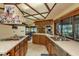 Open kitchen layout with stainless steel appliances, view of brick fireplace, and wood cabinetry at 14449 Wadsworth Dr, Odessa, FL 33556